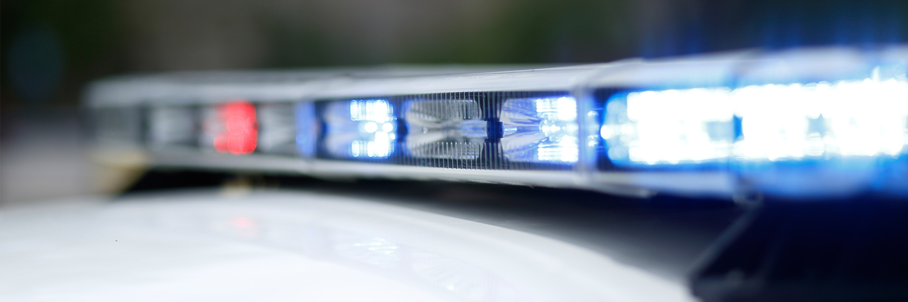 A shallow focus close-up of flashing police lights on an IUPD car.